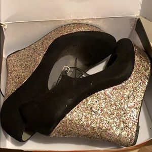 A pair of 11 Black wedges with glitter heels